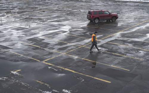 : A patchwork of cracked pavement and puddles